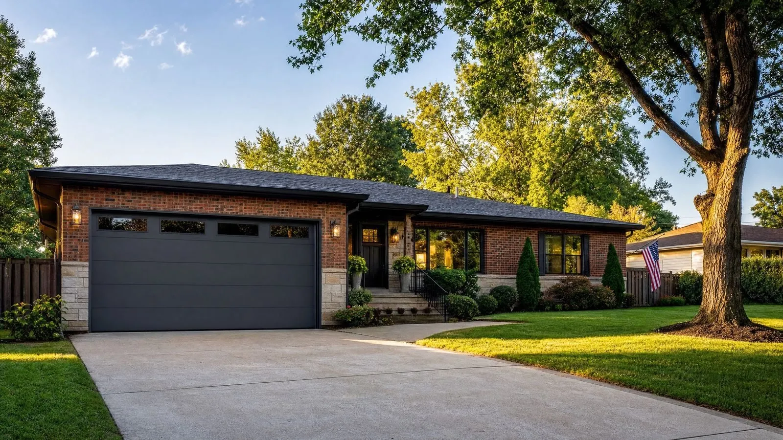 A Chattanooga home with a modern dark C.H.I. plank garage door at golden hour