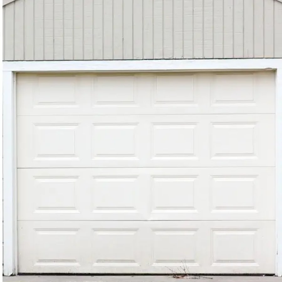 A clean new white garage door after replacement